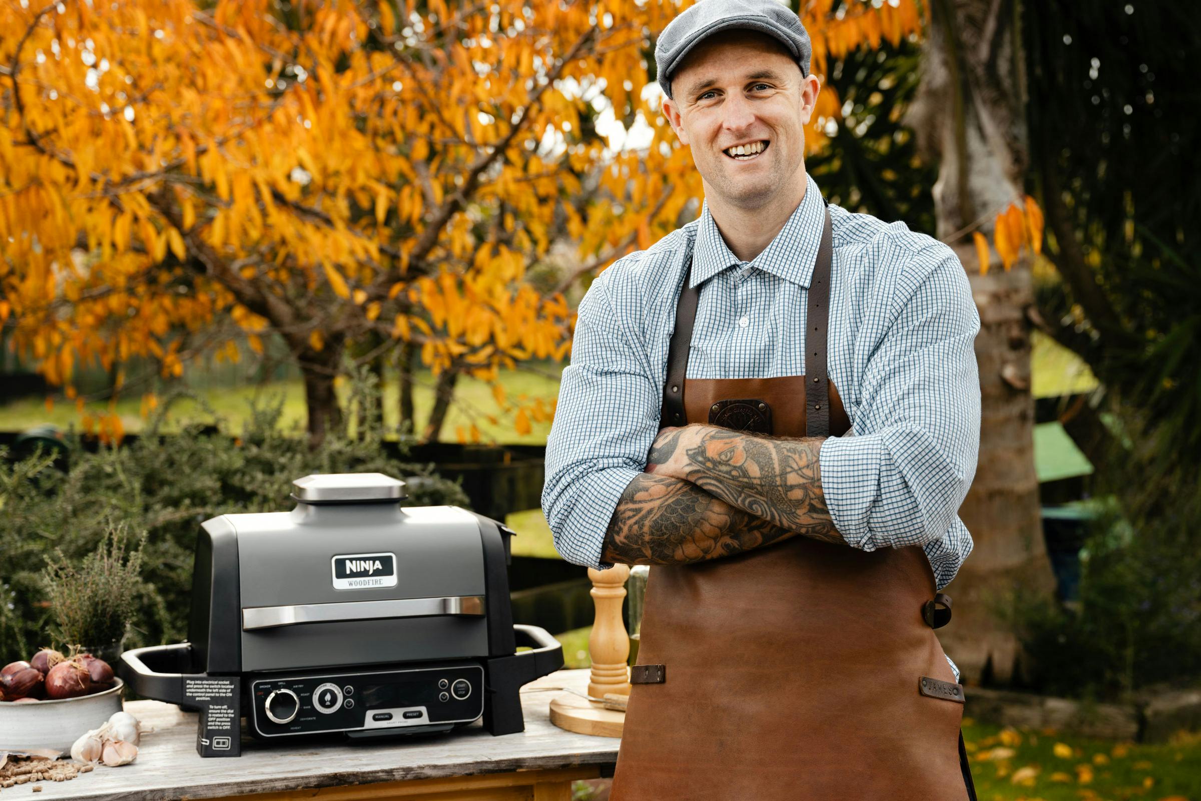 James Smith smiling to camera with the Ninja Grill in the background